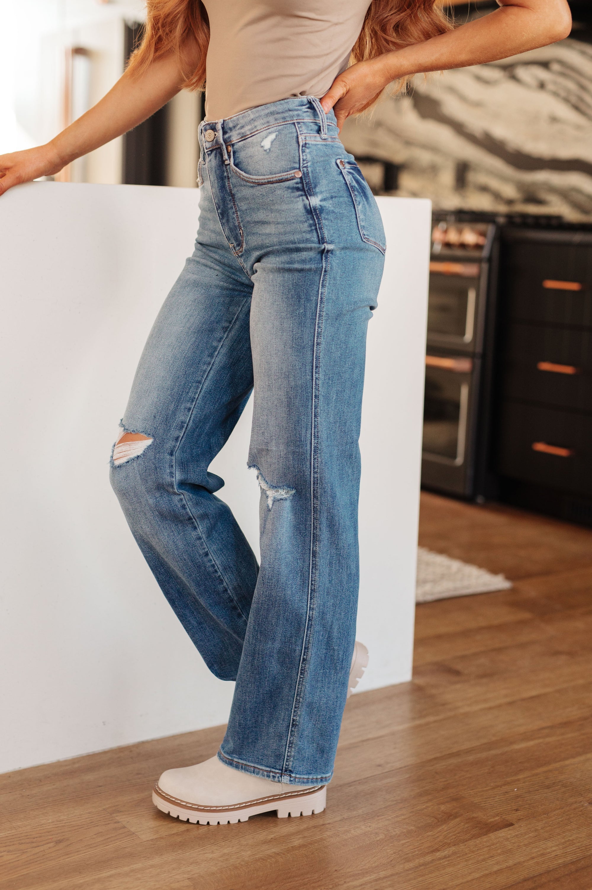 Person wearing blue jeans with a white background