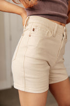 Beige shorts worn by a person with a neutral background