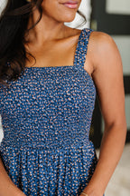 Woman wearing a blue patterned jumpsuit with blurred background