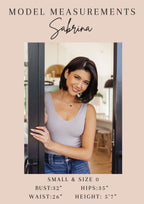 Woman standing in a doorway with model measurements displayed